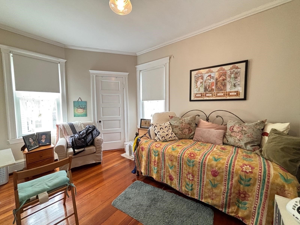 12 White Avenue, Unit 3 Brookline, MA 02467 - Photo 14 of 24 a bedroom with a bed and wooden floor