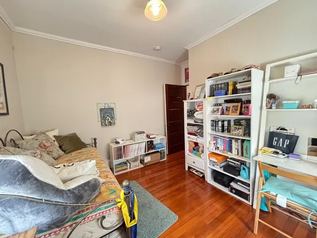 a living room with furniture cabinets and a book shelf