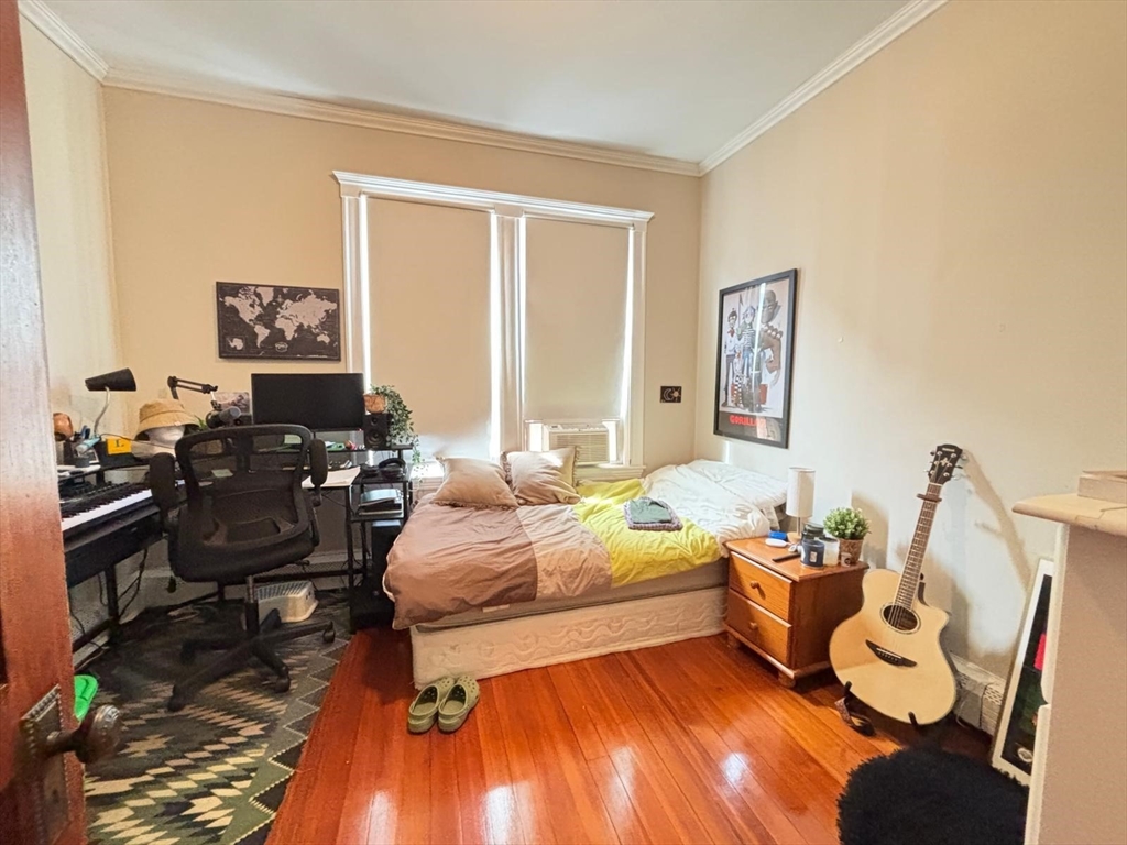 12 White Avenue, Unit 3 Brookline, MA 02467 - Photo 16 of 24 a bedroom with furniture and a wooden floor