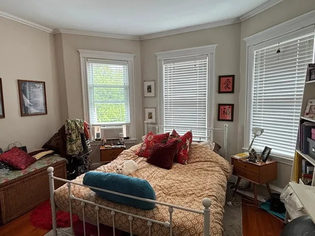 a bedroom with bed and windows