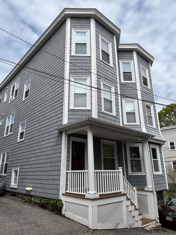 12 White Avenue, Unit 3 Brookline, MA 02467 - Photo 23 of 24 a front view of a house with a porch
