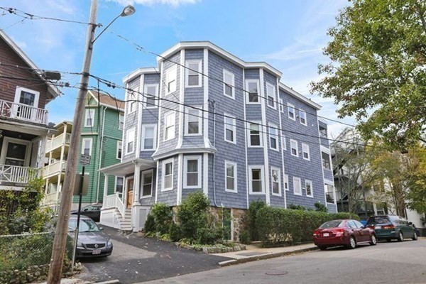 12 White Avenue, Unit 3 Brookline, MA 02467 - Photo 24 of 24 a front view of a building with lot of cars and trees