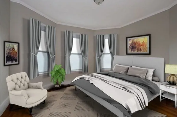 a bedroom with bed couch and a large window