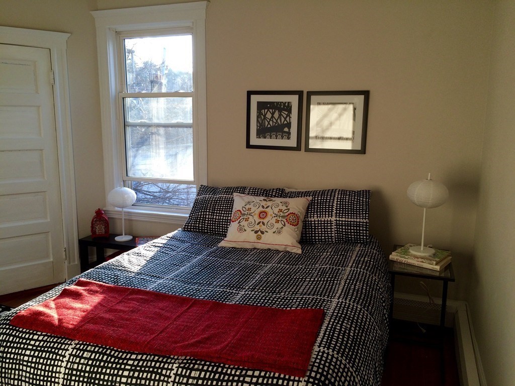 12 White Avenue, Unit 3 Brookline, MA 02467 - Photo 4 of 24 a living room with a couch and a table