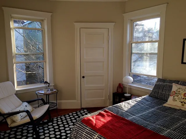 a bedroom with a bed and a window