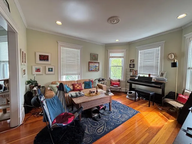 a living room with furniture a rug and a window