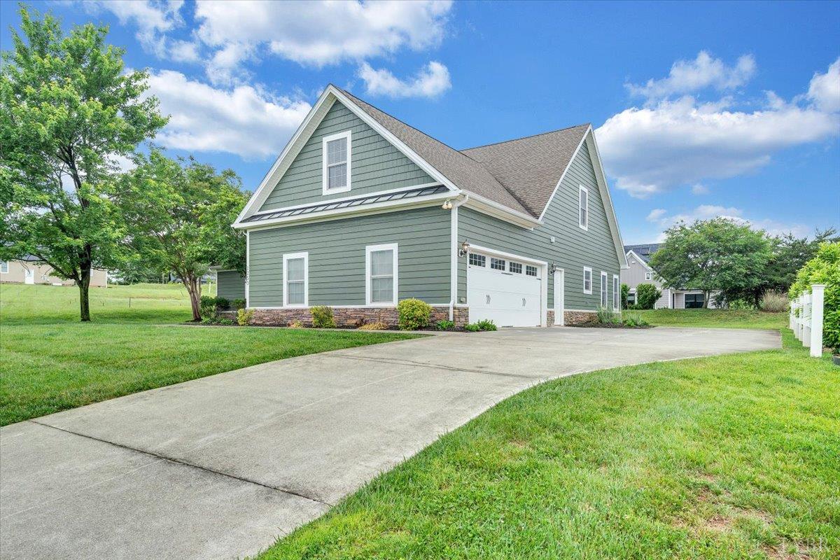 1250 Our Cove Road Huddleston, VA 24104 - Photo 56 of 70 a view of a house next to a yard with big trees