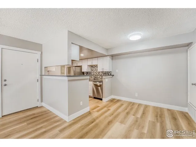 a kitchen with a sink cabinets and wooden floor