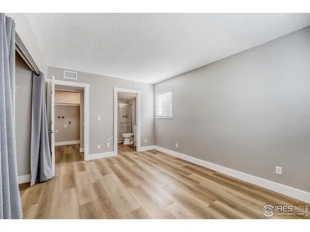 a bathroom with a sink a toilet a mirror and shower