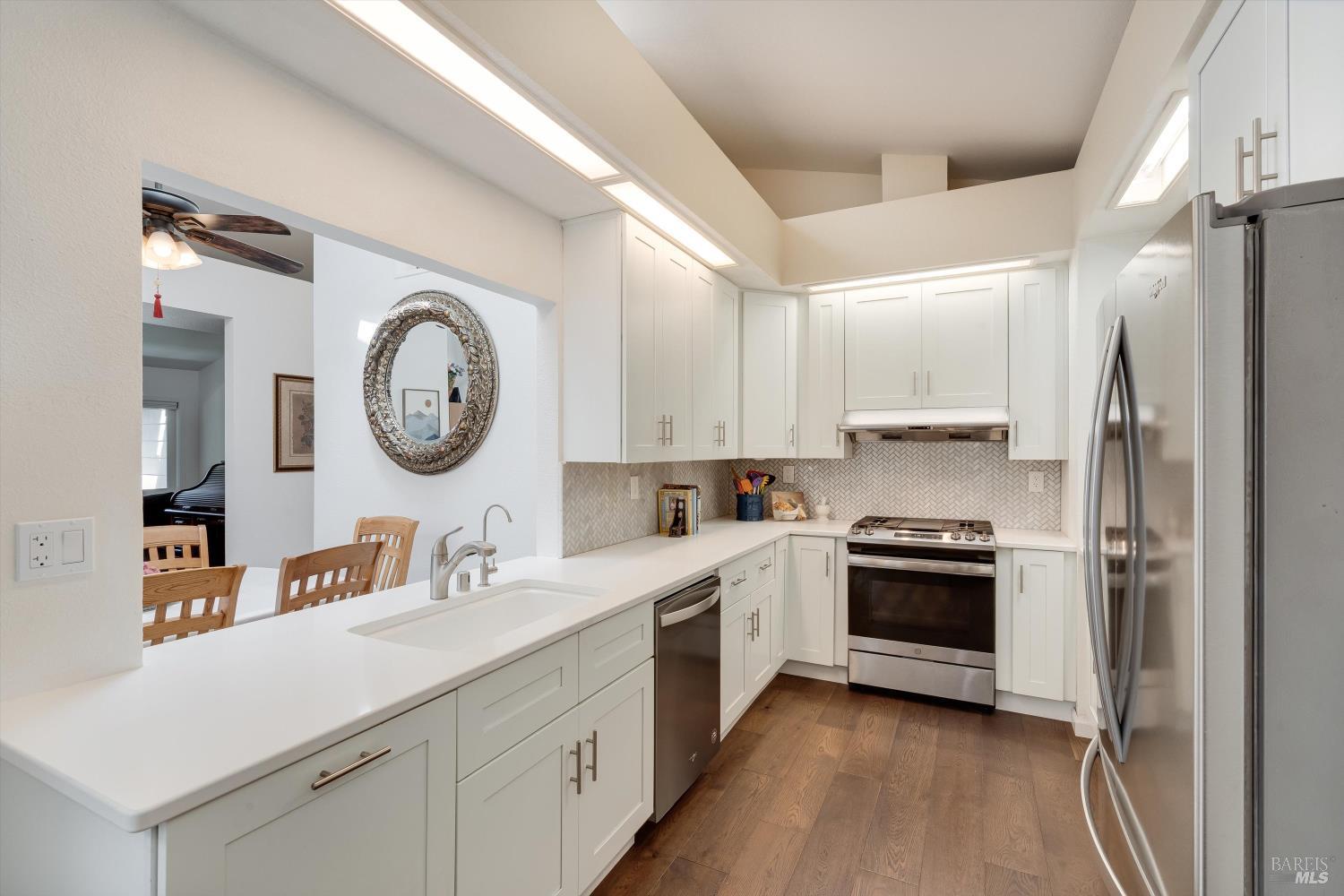 a kitchen with a stove a sink and a refrigerator