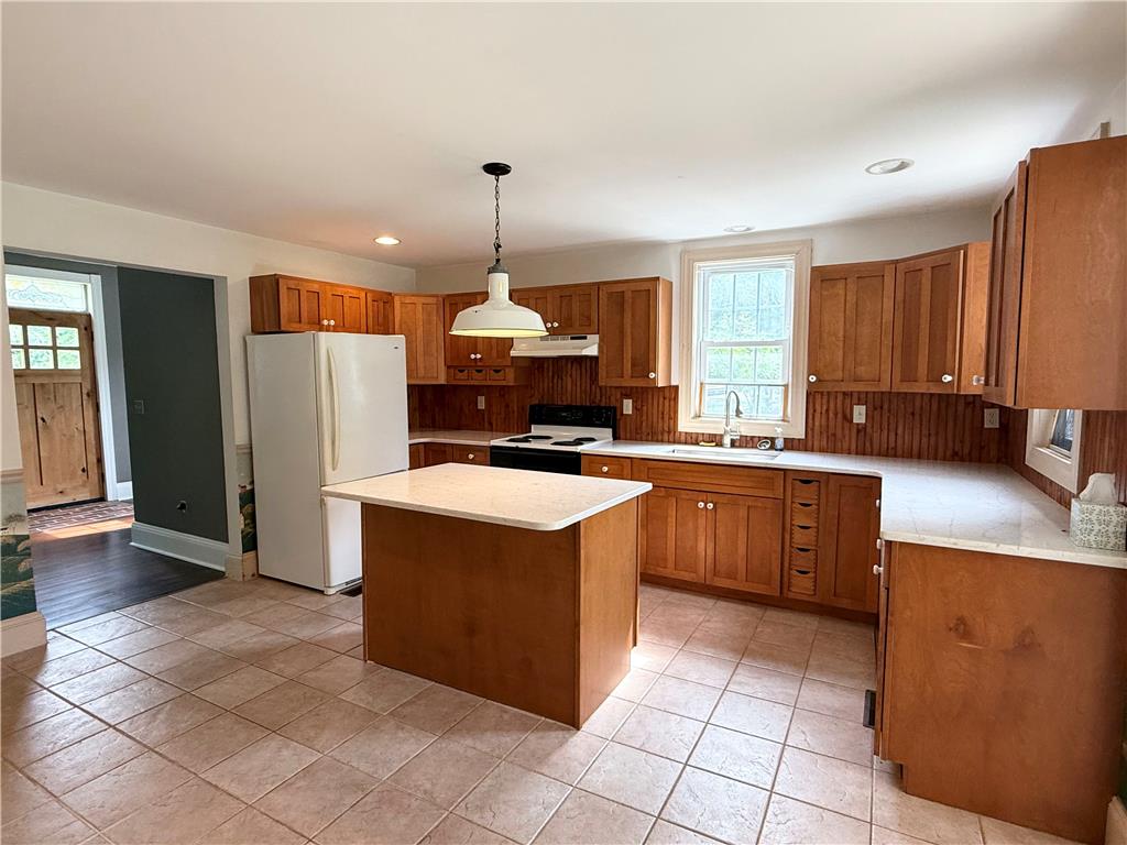 740 Engler Road Nazareth, PA 18064 - Photo 5 of 27 A functional kitchen features warm wood cabinetry, a practical island, and resilient tile flooring.