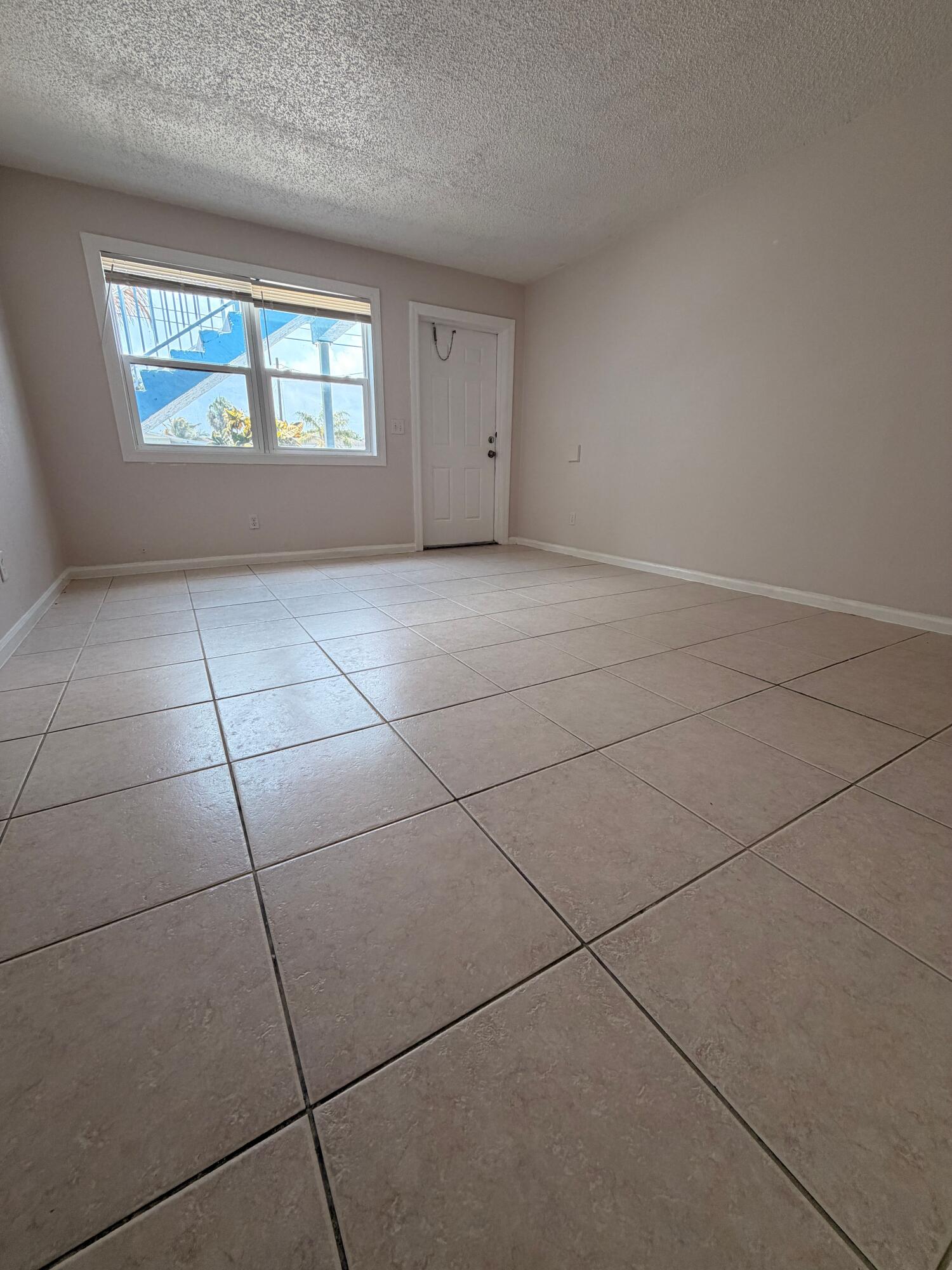 1618 West 26th Court, Unit A Riviera Beach, FL 33404 - Photo 3 of 15 a view of an empty room with windows