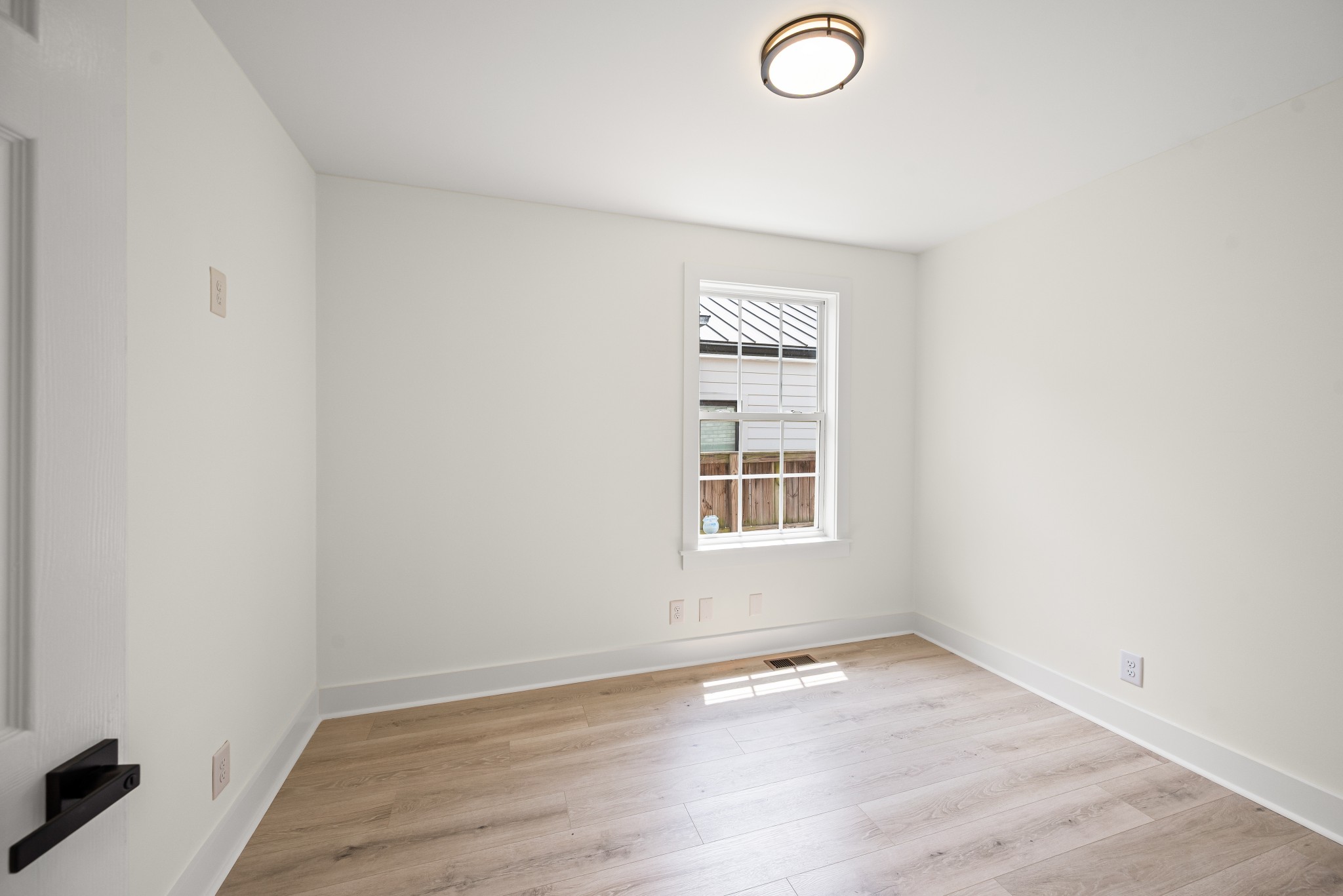 1815 3rd Avenue North Nashville, TN 37208 - Photo 21 of 44 an empty room with wooden floor and windows