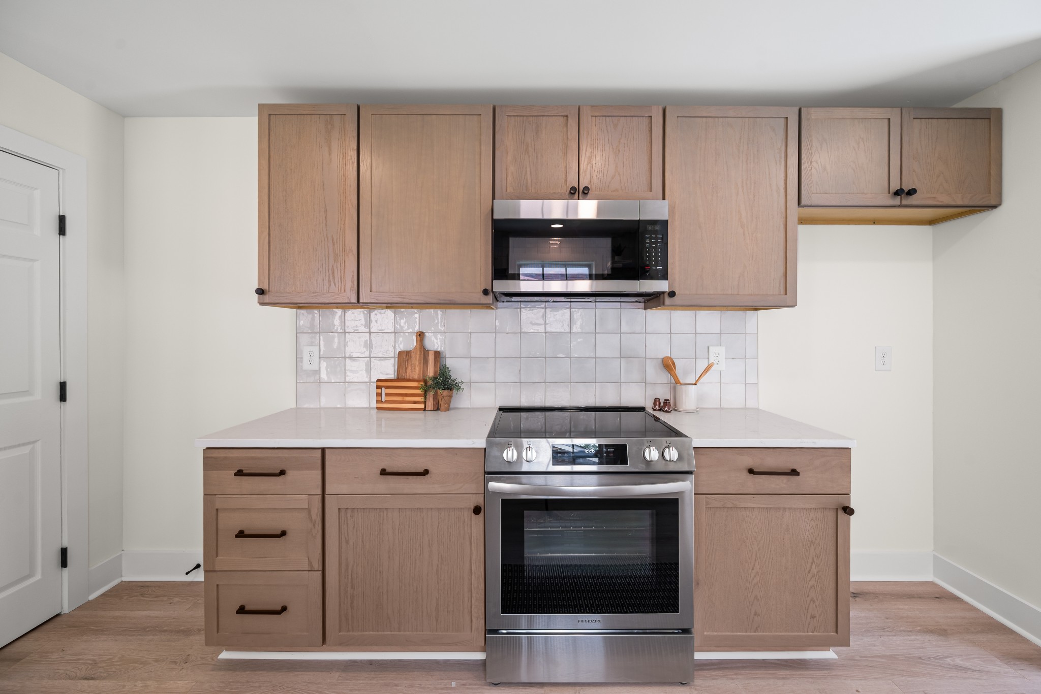 1815 3rd Avenue North Nashville, TN 37208 - Photo 9 of 44 a kitchen with cabinets stainless steel appliances and wooden floor