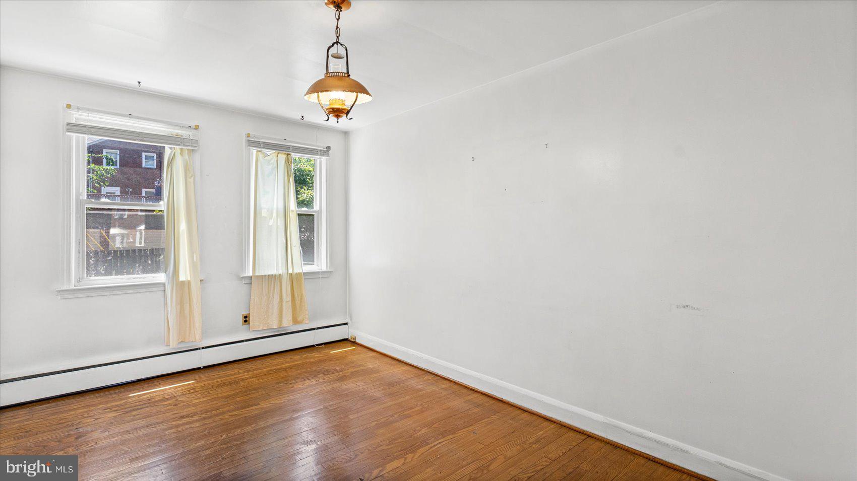 1805 Crestview Road Baltimore, MD 21239 - Photo 11 of 39 a view of empty room with wooden floor and fan