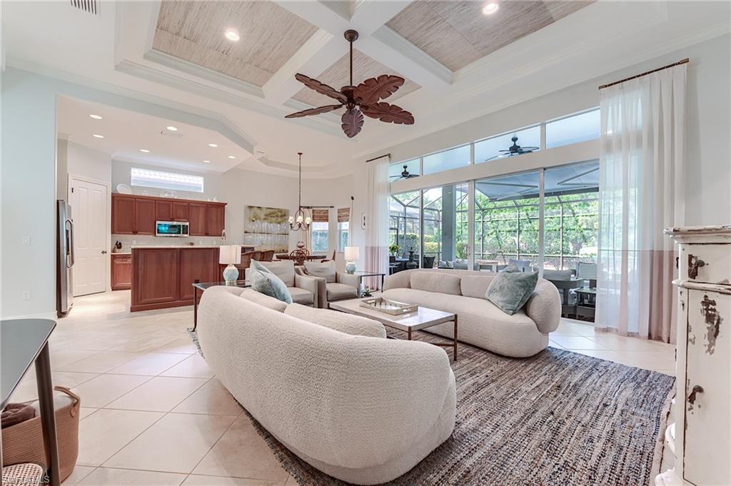 7699 Cottesmore Drive Naples, FL 34113 - Photo 14 of 37 a living room with furniture and a large window