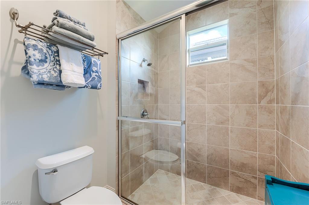 7699 Cottesmore Drive Naples, FL 34113 - Photo 24 of 37 a bathroom with a toilet and shower