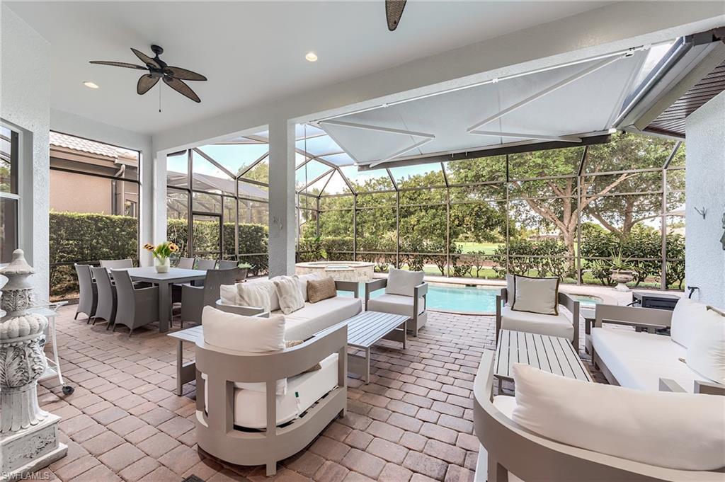7699 Cottesmore Drive Naples, FL 34113 - Photo 27 of 37 a living room with patio furniture and a large window