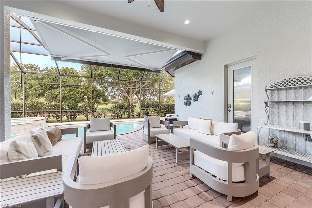 7699 Cottesmore Drive Naples, FL 34113 - Photo 28 of 37 a living room with furniture and a large window