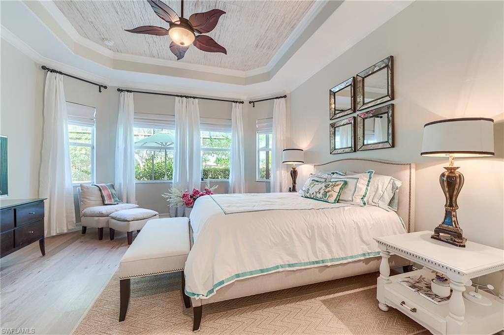 7699 Cottesmore Drive Naples, FL 34113 - Photo 3 of 37 a bedroom with a bed and wooden floor