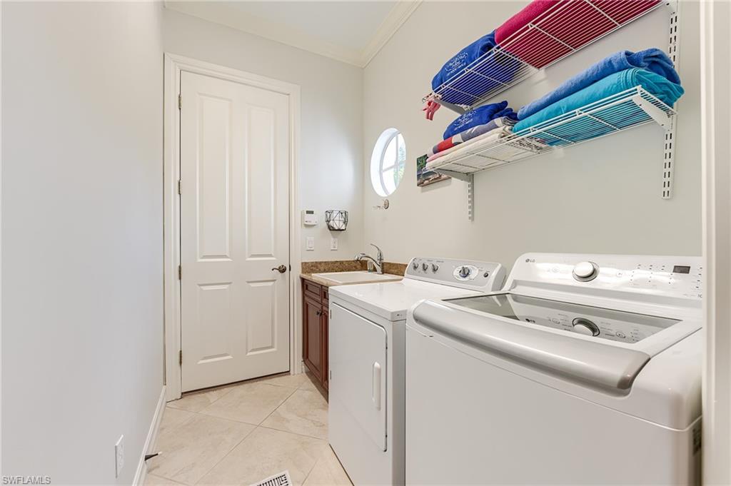 7699 Cottesmore Drive Naples, FL 34113 - Photo 31 of 37 a utility room with dryer and washer