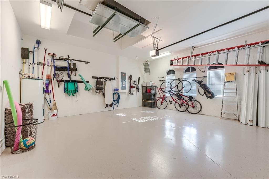 7699 Cottesmore Drive Naples, FL 34113 - Photo 32 of 37 a view of a garage with a bike and white roof
