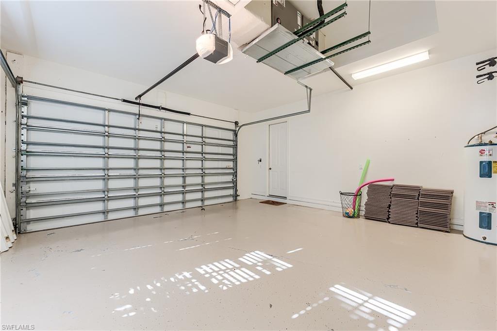 7699 Cottesmore Drive Naples, FL 34113 - Photo 33 of 37 a view of a garage