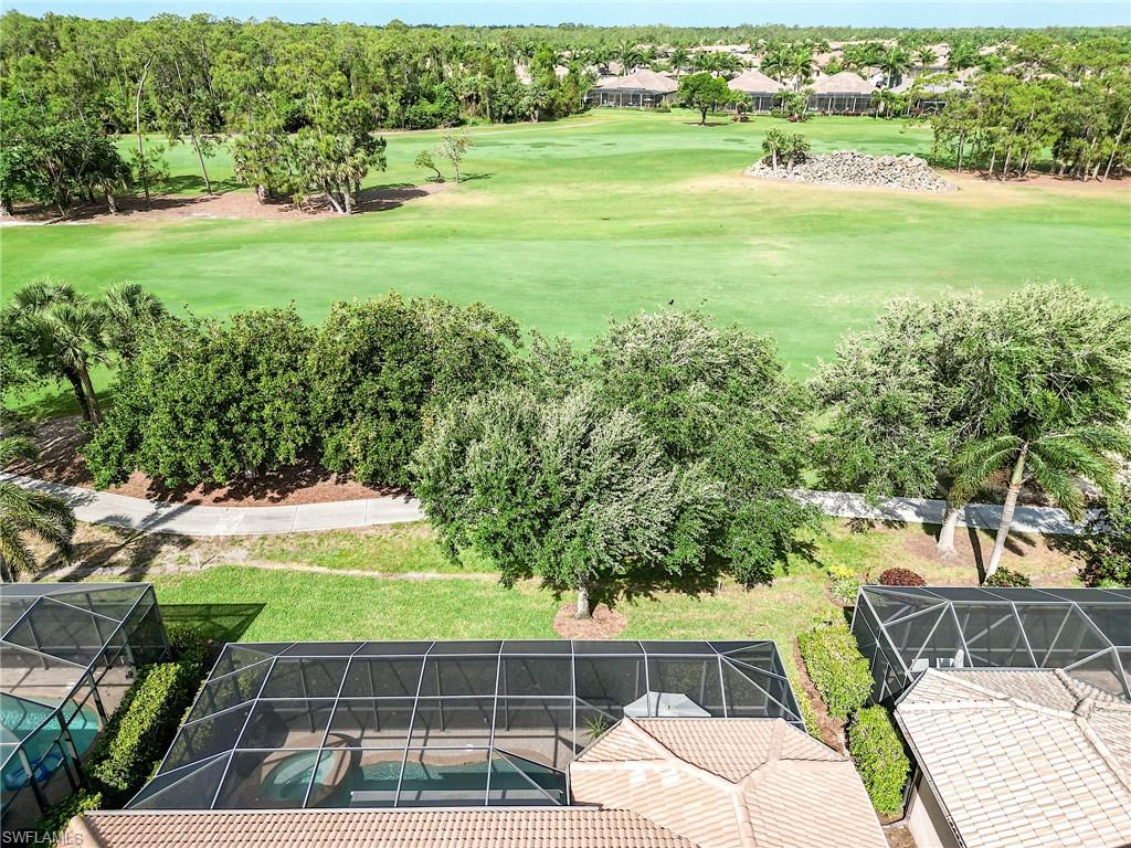 7699 Cottesmore Drive Naples, FL 34113 - Photo 34 of 37 a view of a yard with an outdoor space
