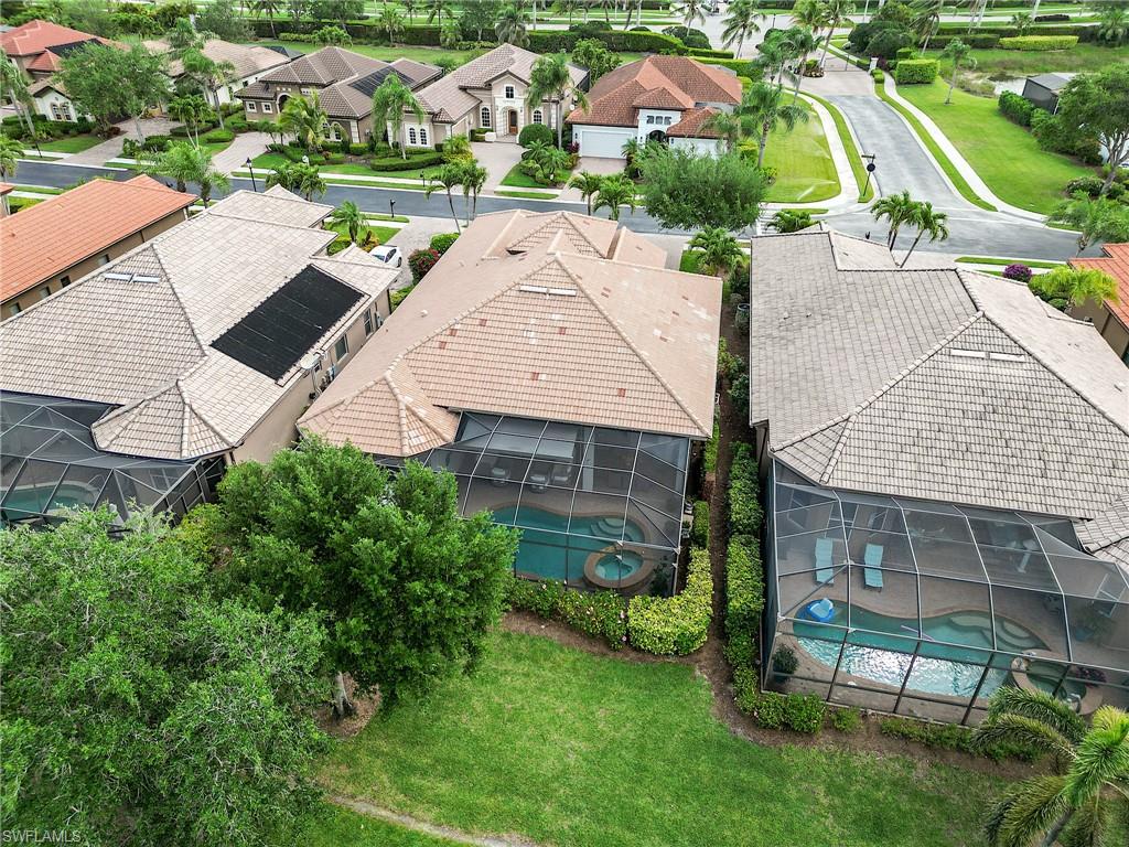 7699 Cottesmore Drive Naples, FL 34113 - Photo 35 of 37 an aerial view of a house with garden space and street view
