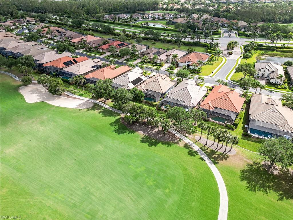 7699 Cottesmore Drive Naples, FL 34113 - Photo 36 of 37 an aerial view of a houses with a lake view