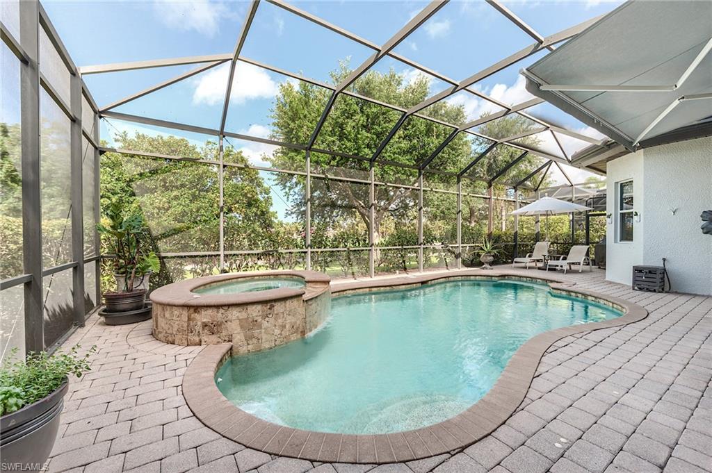 7699 Cottesmore Drive Naples, FL 34113 - Photo 4 of 37 a view of a swimming pool with a patio