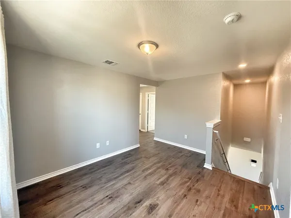 a view of a livingroom with a ceiling fan and window