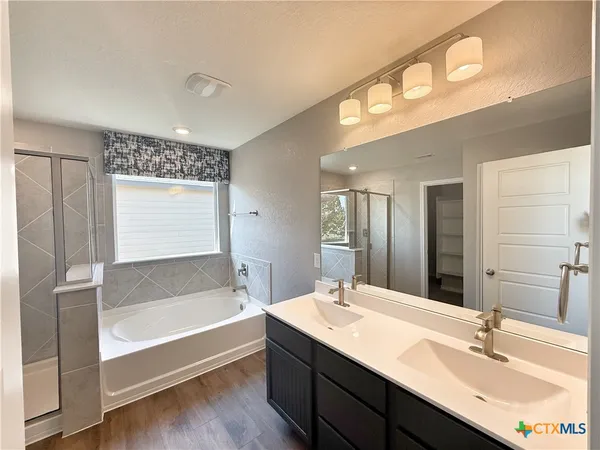 a view of a hallway with wooden floor and closet area