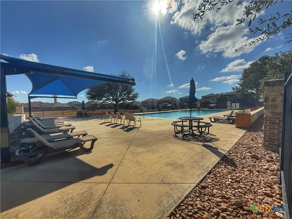 a view of a swimming pool with a patio