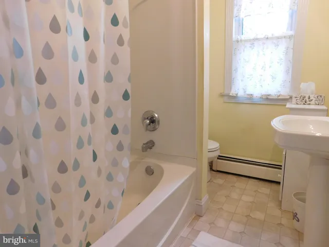 a view of room with window and cabinet