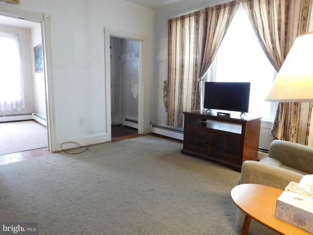 a livingroom with workspace and a window