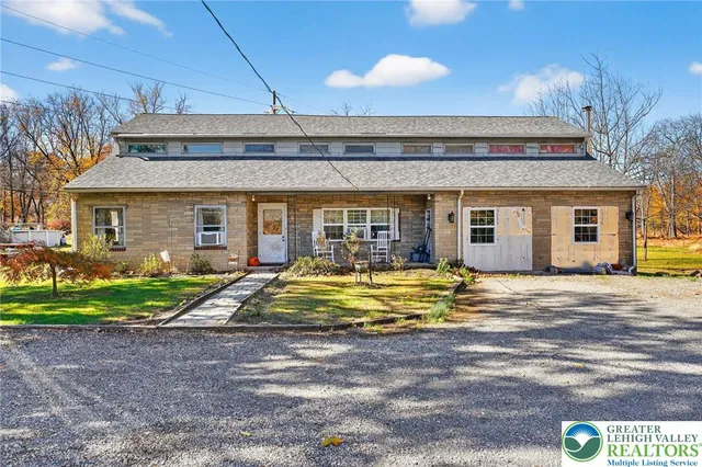 a view of a house with backyard and swimming pool