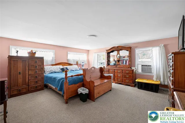 a bedroom with furniture and a large window