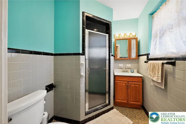 a bathroom with a shower and a sink