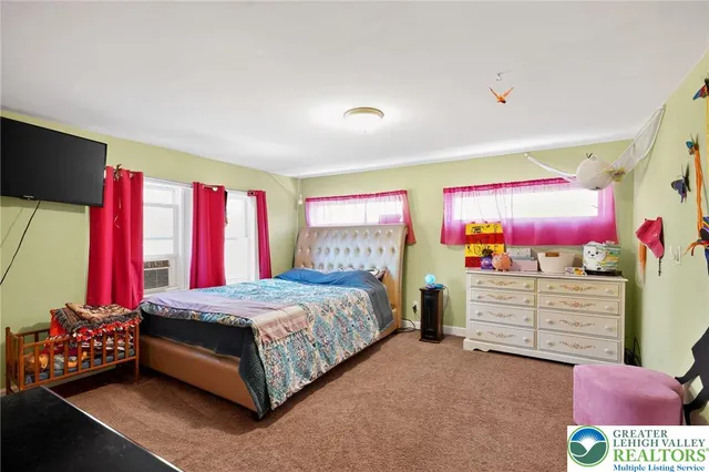 a bedroom with a bed and a dresser