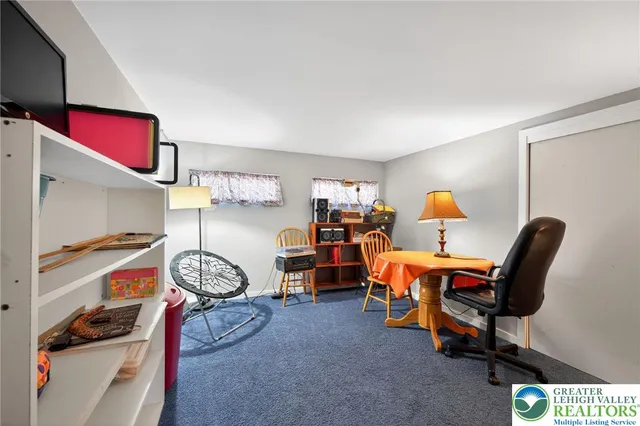 a view of a room with workspace and windows