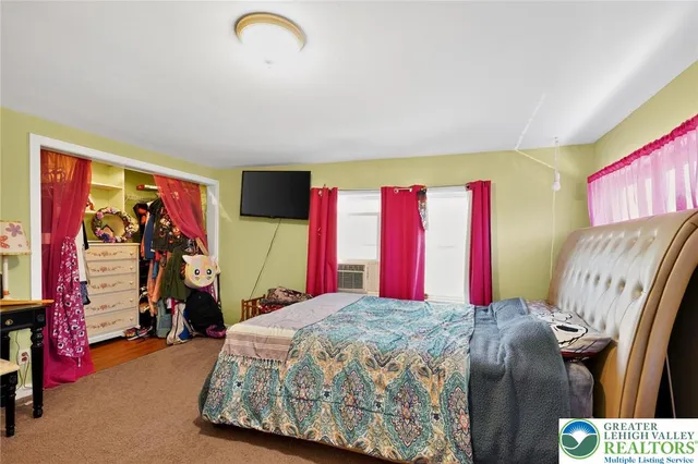 a bed sitting in a room next to a window