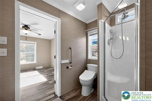a bathroom with a toilet and a shower