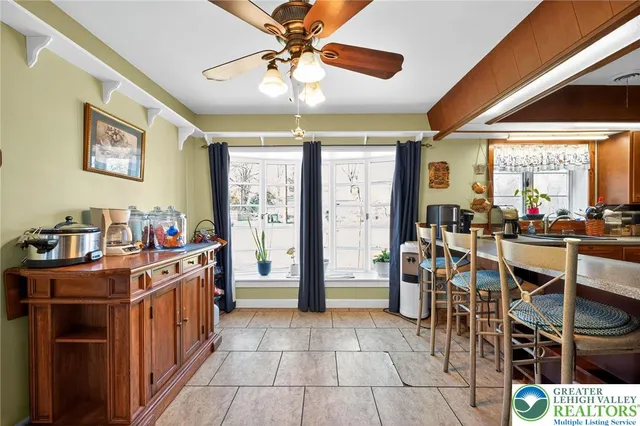 a kitchen filled with stainless steel appliances kitchen island granite countertop a table and chairs in it