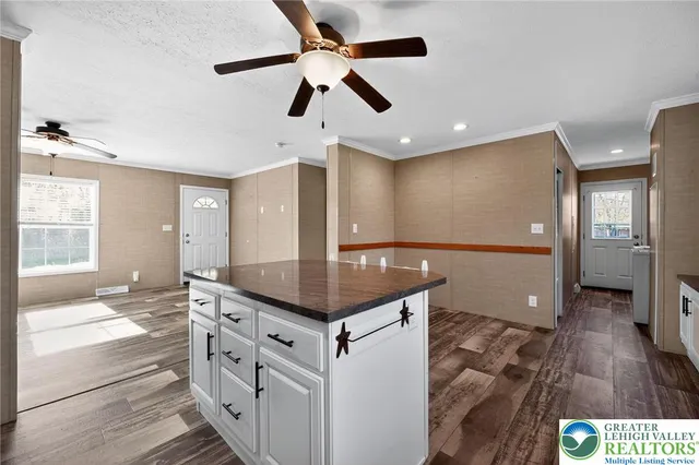 a kitchen with stainless steel appliances granite countertop a refrigerator a sink and a stove