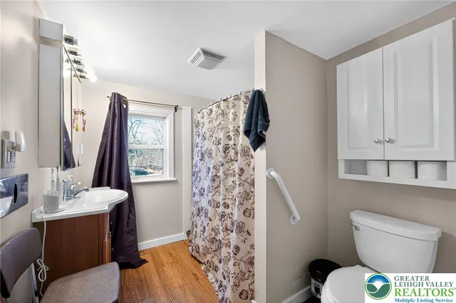 a bathroom with a toilet sink and mirror