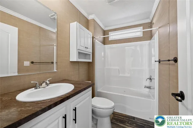 a bathroom with a sink toilet tub and shower