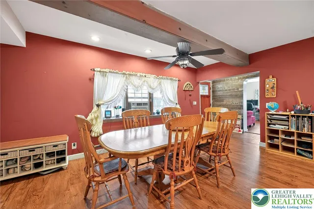 a dining room with furniture a chandelier and wooden floor