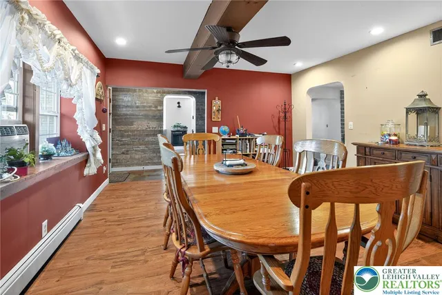 a view of a dining room with furniture and a floor to ceiling window
