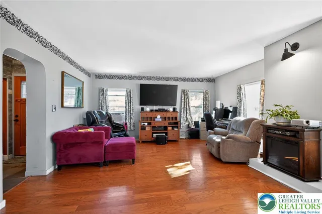 a living room with furniture and a flat screen tv